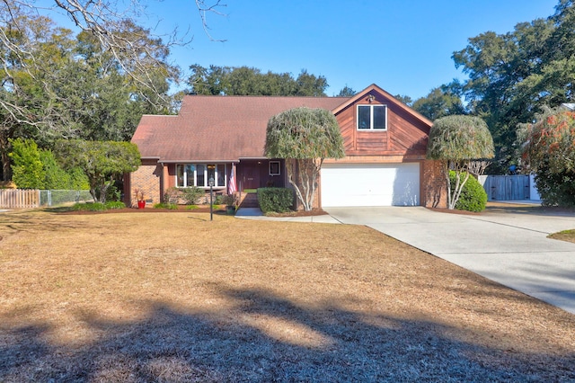 view of front of home with a front yard and a garage