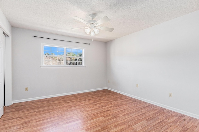 111 Elmwood Ave Unit A, Ladson, SC 29456 - unfurnished bedroom with light wood-style floors, a textured ceiling, a closet, baseboards, and ceiling fan