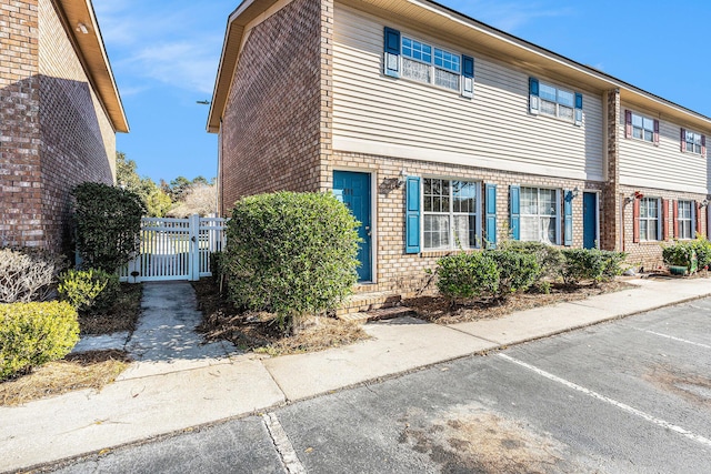 111 Elmwood Ave Unit A, Ladson, SC 29456 - view of front facade featuring brick siding, entry steps, fence, and a gate