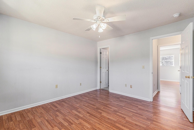111 Elmwood Ave Unit A, Ladson, SC 29456 - unfurnished bedroom featuring wood finished floors, a textured ceiling, baseboards, and ceiling fan