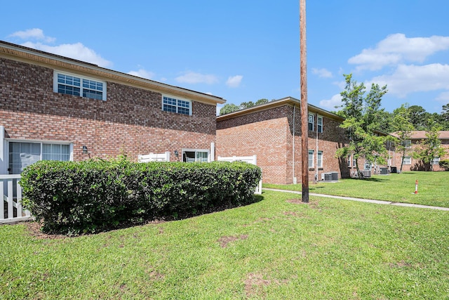 111 Elmwood Ave Unit A, Ladson, SC 29456 - view of property exterior with brick siding, a yard, and central AC