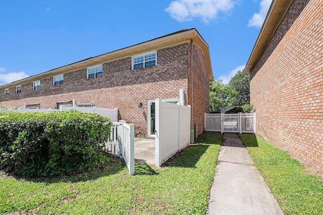 111 Elmwood Ave Unit A, Ladson, SC 29456 - view of property exterior with a gate and brick siding