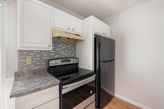 111 Elmwood Ave Unit A, Ladson, SC 29456 - kitchen featuring electric stove, under cabinet range hood, freestanding refrigerator, decorative backsplash, and white cabinetry