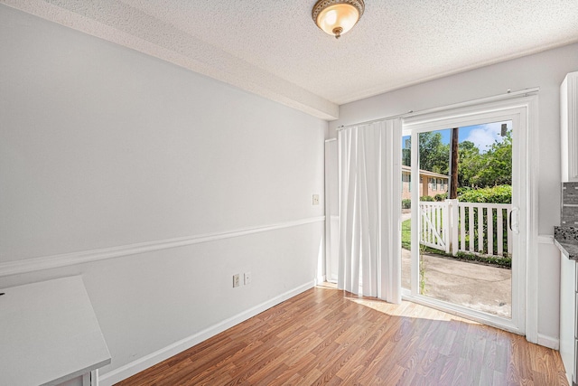 111 Elmwood Ave Unit A, Ladson, SC 29456 - empty room with light wood-type flooring, a textured ceiling, and baseboards