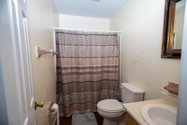 bathroom with a shower with curtain, vanity, and toilet