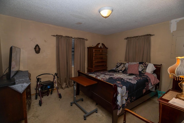 bedroom with electric panel, light colored carpet, and a textured ceiling