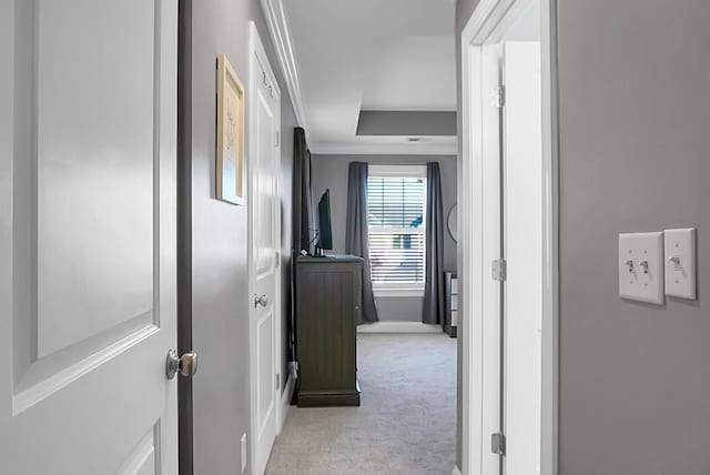 hall featuring light colored carpet and crown molding