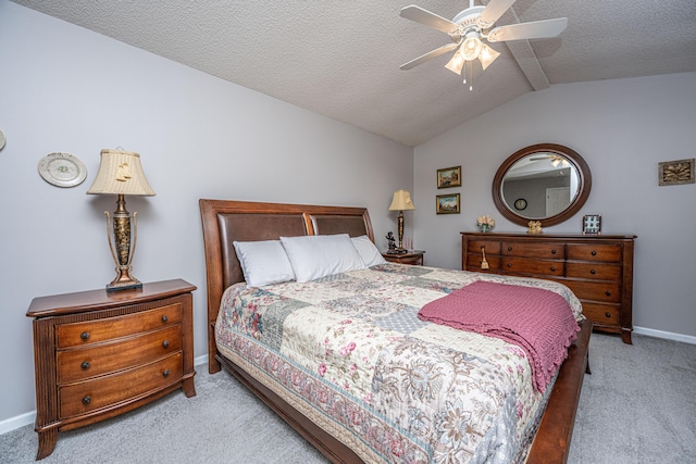 carpeted bedroom with ceiling fan, a textured ceiling, and lofted ceiling