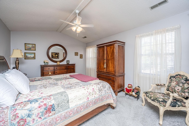 bedroom with a textured ceiling, ceiling fan, carpet, and vaulted ceiling