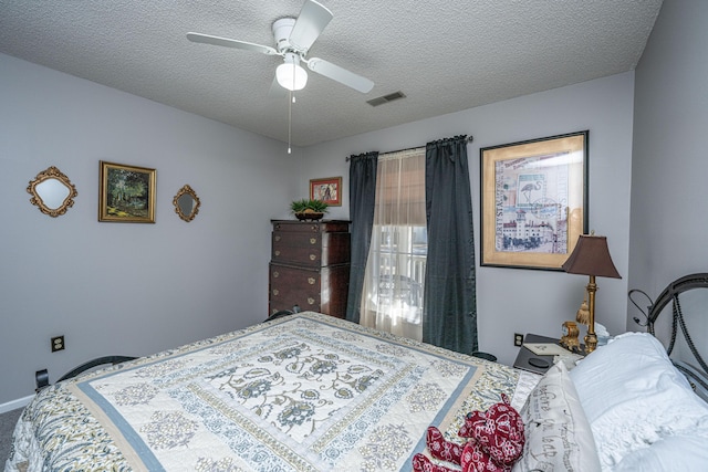 carpeted bedroom with a textured ceiling and ceiling fan