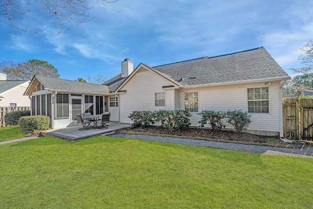 back of house with a sunroom, a lawn, and a patio