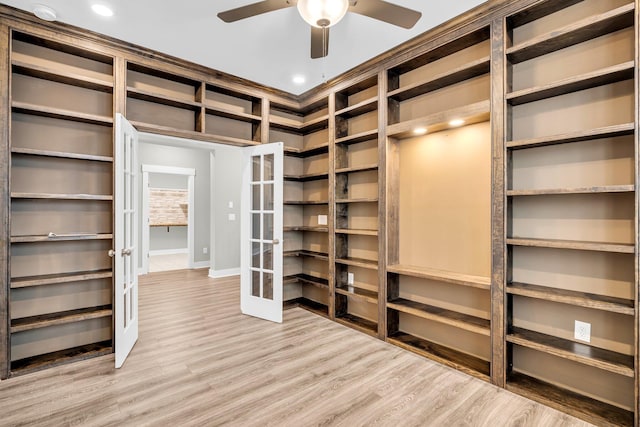 walk in closet with hardwood / wood-style flooring and ceiling fan