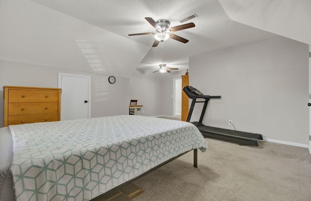 carpeted bedroom with ceiling fan, vaulted ceiling, and a textured ceiling