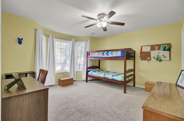 bedroom with light carpet, a textured ceiling, and ceiling fan