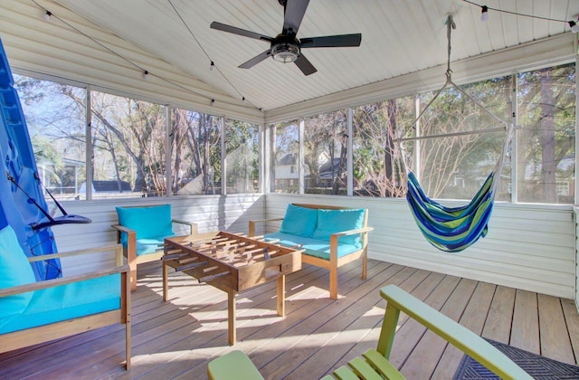 sunroom with ceiling fan and lofted ceiling