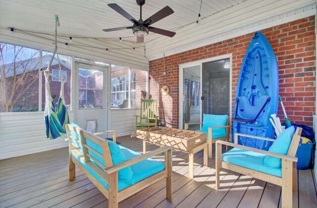 wooden deck featuring ceiling fan