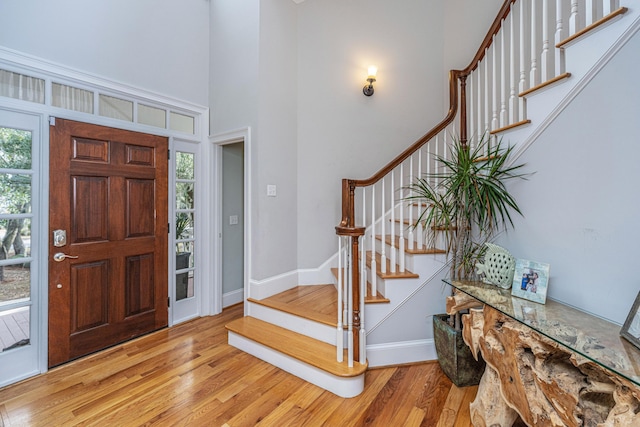 foyer with a high ceiling and light wood-type flooring