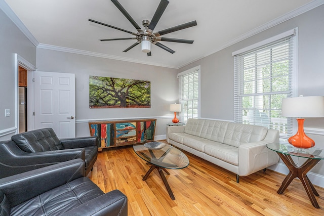 living room featuring light hardwood / wood-style flooring, ornamental molding, and ceiling fan