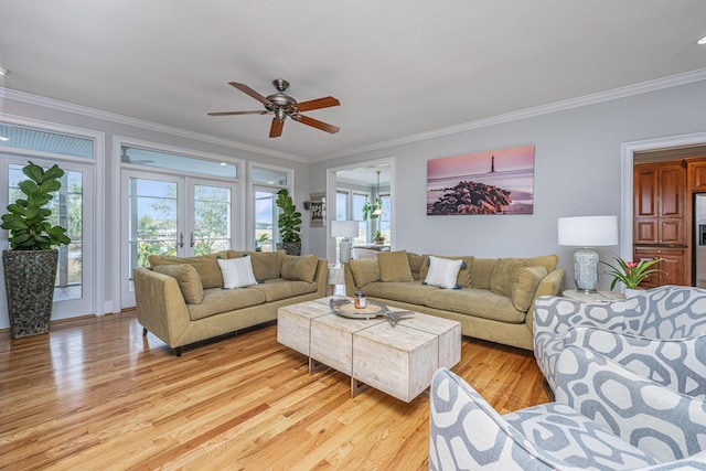 living room featuring ornamental molding, french doors, ceiling fan, and light wood-type flooring