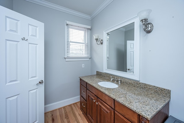 bathroom featuring vanity, hardwood / wood-style floors, and ornamental molding