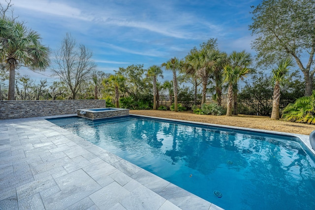 view of pool with an in ground hot tub and a patio area