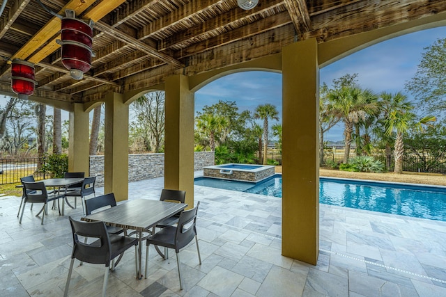 view of patio with ceiling fan and a pool with hot tub