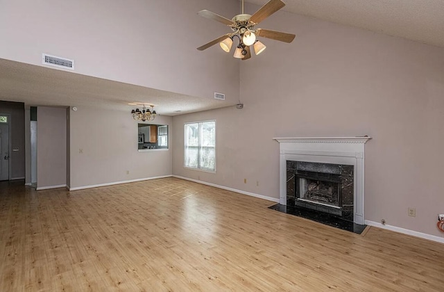 unfurnished living room featuring a fireplace, light hardwood / wood-style flooring, and ceiling fan