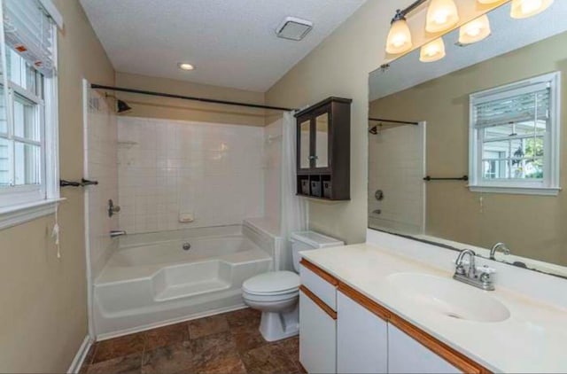 full bathroom with plenty of natural light, tub / shower combination, a textured ceiling, and toilet