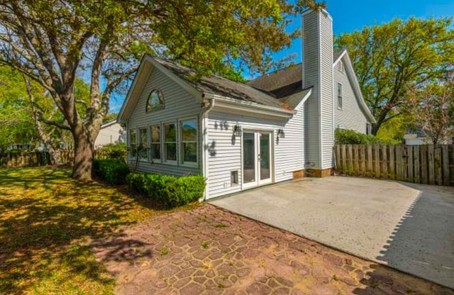 rear view of property featuring a patio area and french doors