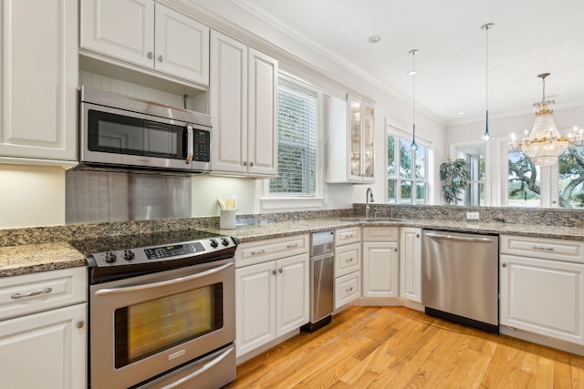 kitchen featuring white cabinetry, appliances with stainless steel finishes, and light hardwood / wood-style floors