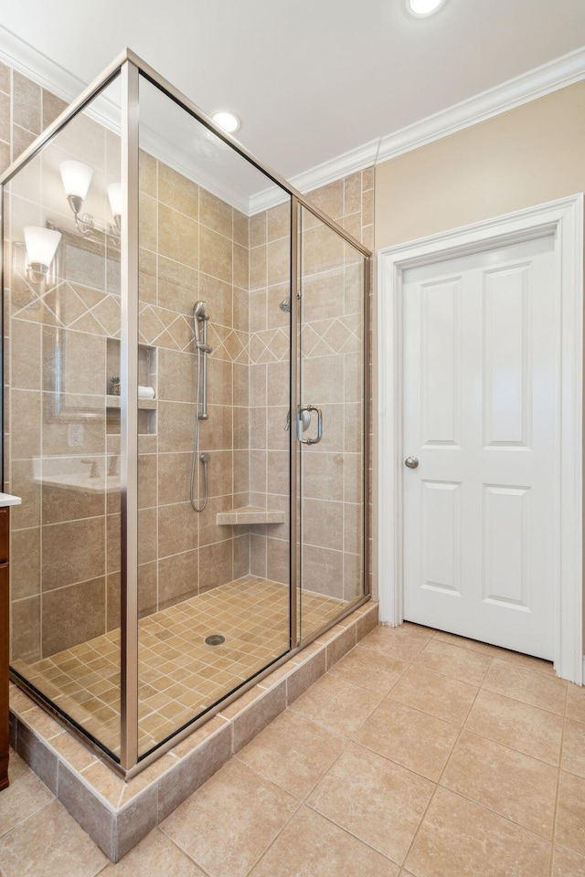 bathroom featuring a shower with door, tile patterned floors, and ornamental molding