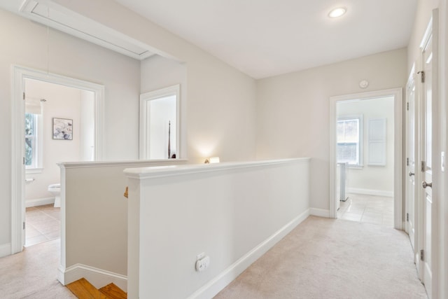 hallway with light colored carpet