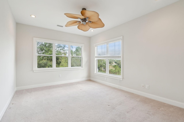 carpeted spare room featuring ceiling fan