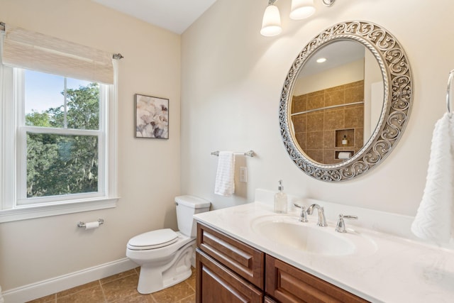 bathroom featuring vanity, tile patterned floors, and toilet