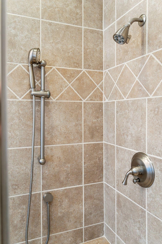 interior details with a tile shower