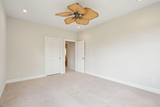 unfurnished bedroom featuring ceiling fan and light carpet