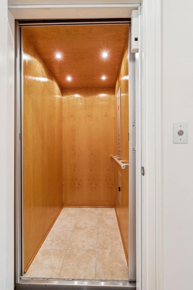 room details with elevator and tile patterned flooring