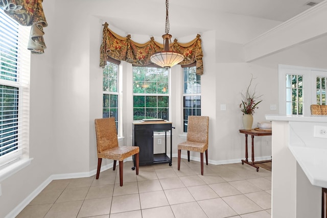 living area featuring light tile patterned floors and baseboards