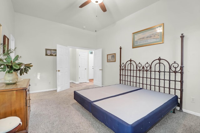 carpeted bedroom with a ceiling fan and baseboards