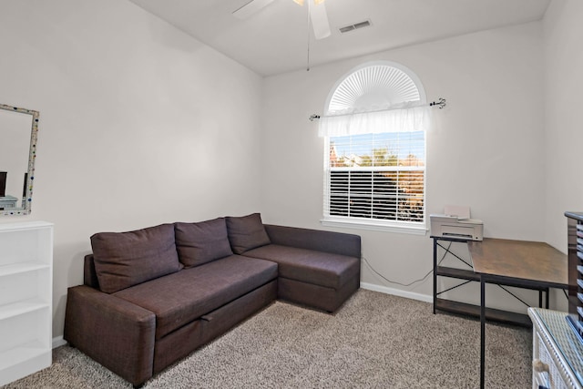 carpeted living area featuring visible vents, baseboards, and ceiling fan