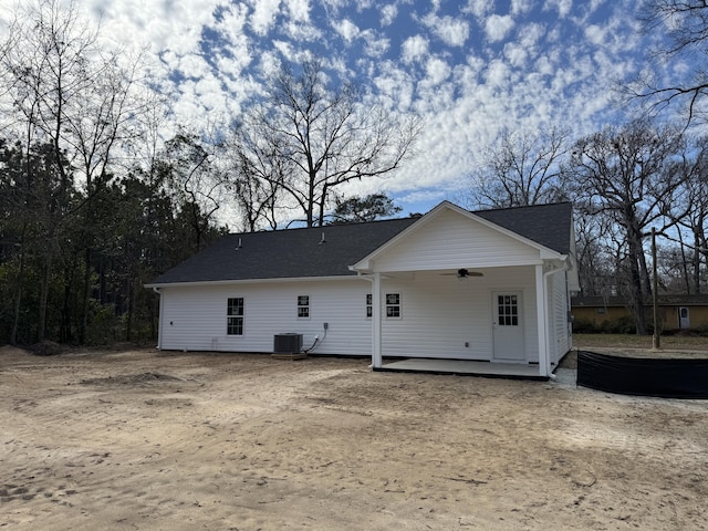 rear view of house featuring central AC and ceiling fan