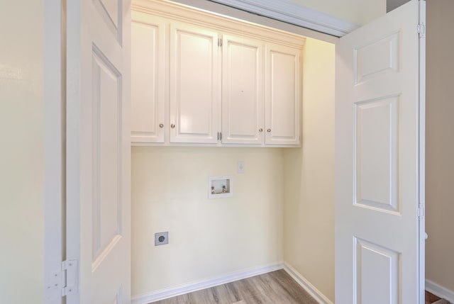 clothes washing area featuring hookup for a washing machine, hookup for an electric dryer, cabinet space, and baseboards