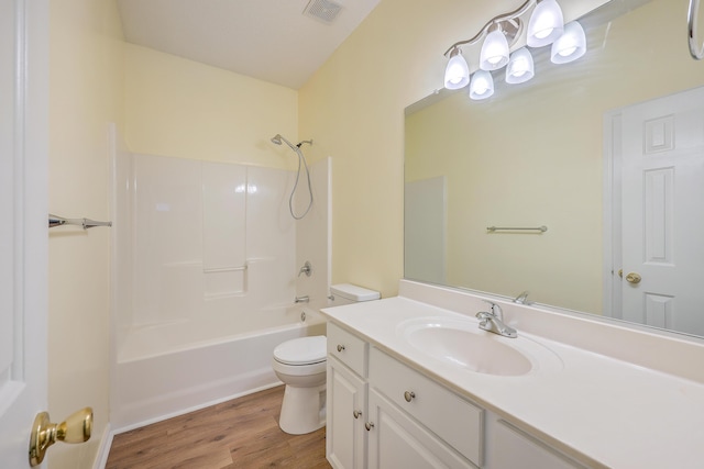full bath featuring toilet, wood finished floors, vanity, visible vents, and  shower combination