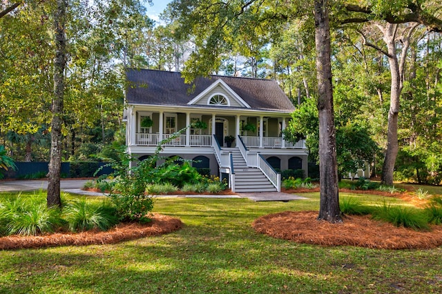 view of front facade with a front yard and covered porch