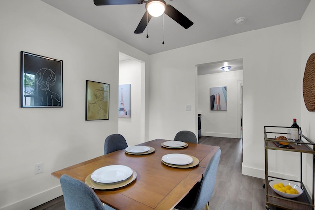 dining room with hardwood / wood-style flooring and ceiling fan