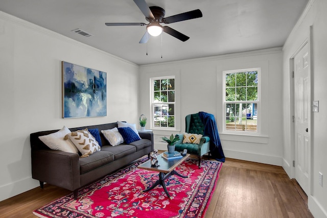 living room featuring crown molding, hardwood / wood-style floors, and ceiling fan