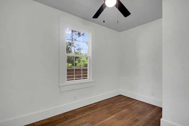 unfurnished room featuring dark hardwood / wood-style floors and ceiling fan