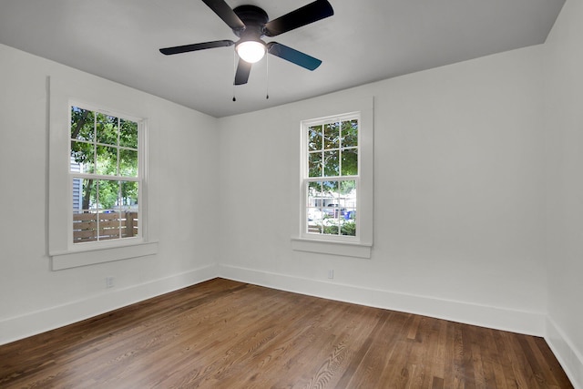 unfurnished room featuring hardwood / wood-style floors, ceiling fan, and a wealth of natural light