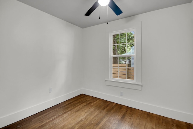 empty room with hardwood / wood-style flooring and ceiling fan