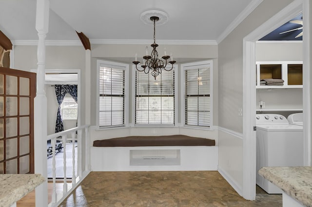 dining space with a chandelier, crown molding, and washing machine and clothes dryer